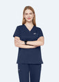 Navy ProEase™ Basic women's scrub top on model, front view with arms folded by COMENII