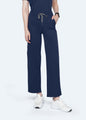 Navy StyleFlex™ 6-Pocket women's scrub pants front fit on model by COMENII