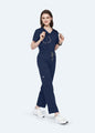Navy StyleFlex™ 6-Pocket women's scrub pants with matching scrub top, full-length view by COMENII