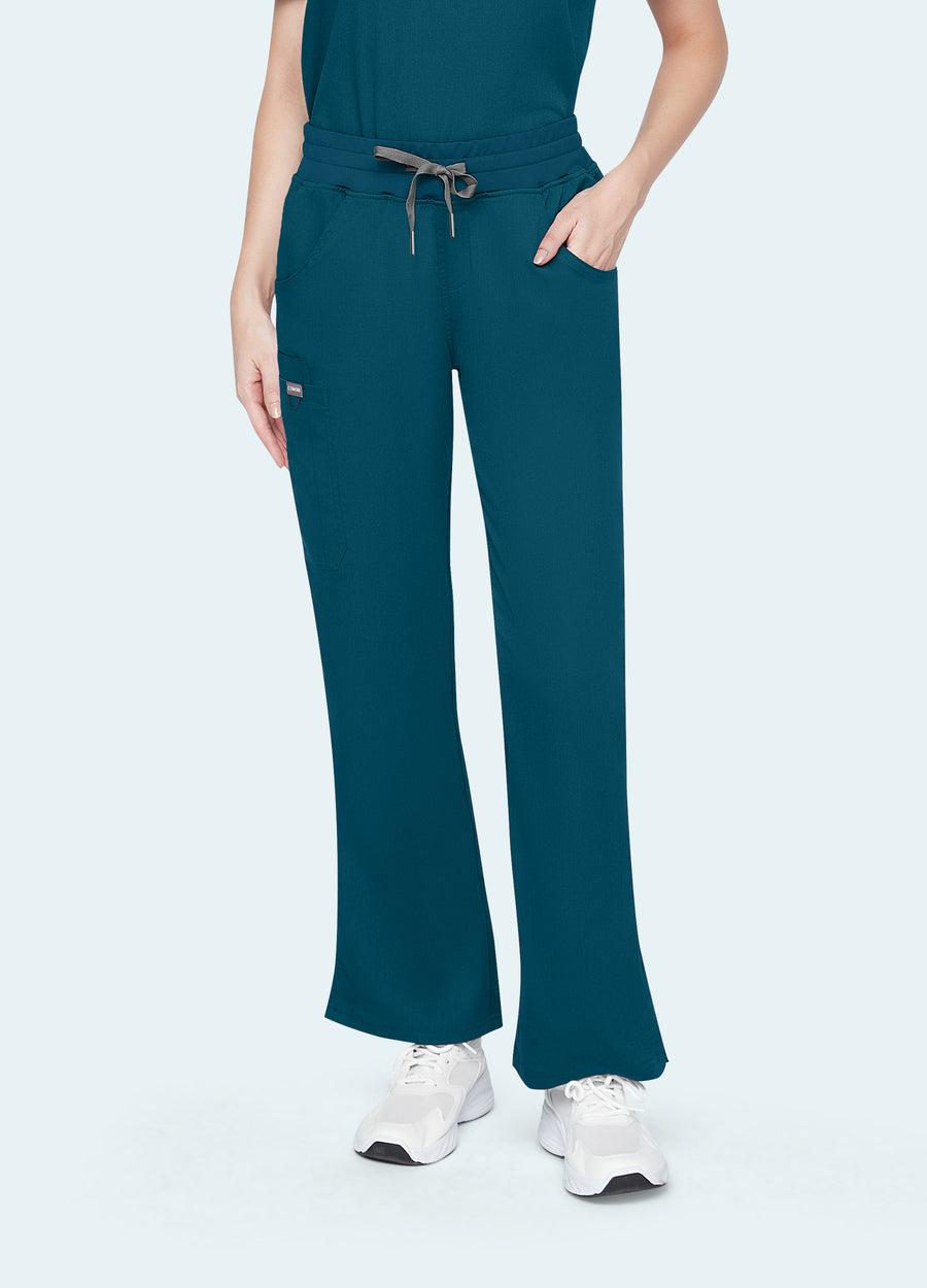Caribbean Blue StyleFlex™ Essential women's scrub pants on model, front fit by COMENII