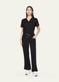 Black StyleFlex™ Essential women's scrub pants with matching scrub top, full-length view by COMENII