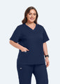 Navy StyleFlex™ Plus Size women's scrub top front fit with hand in pocket by COMENII