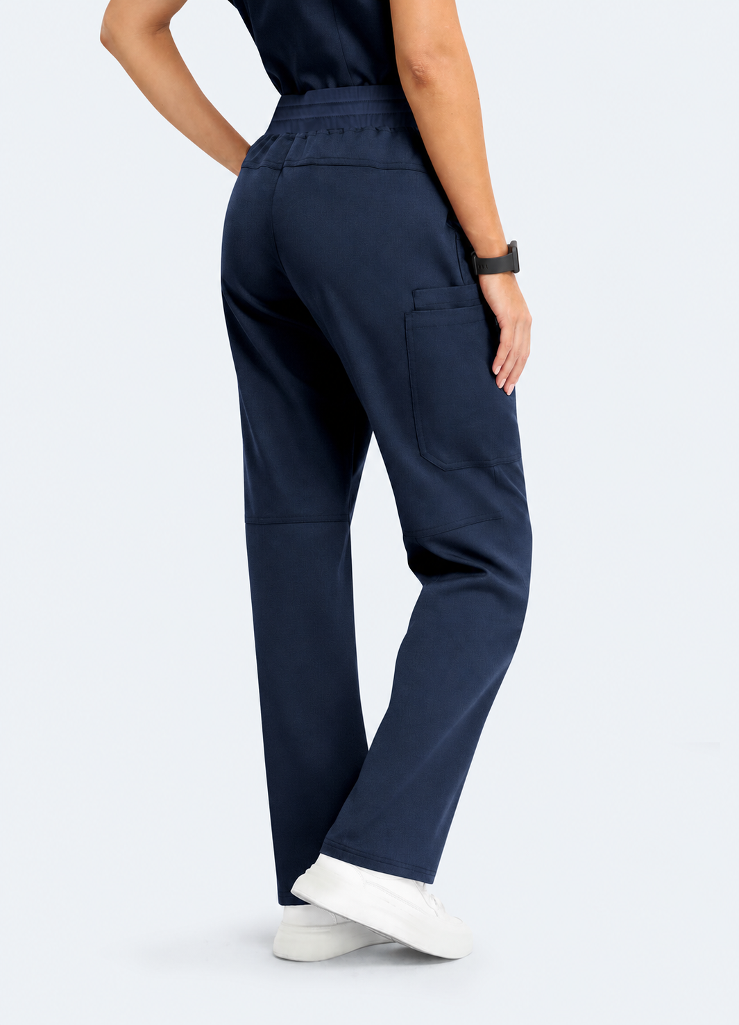 Midnight Navy StyleFlex™ Essential women's scrub pants on model, rear three-quarter fit by COMENII
