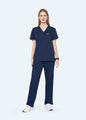 Navy ProEase™ Basic women's scrub top with matching scrub pants, full-length view by COMENII