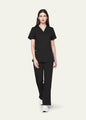 Black SoftTouch™ Essential women's scrub top with matching scrub pants, full-length view by COMENII